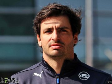 Person in Puma jacket with Gulf logo.